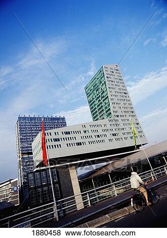Man Cycling By Modern Architecture In Lille View Large Photo Image Stock Photo - Man Cycling By Modern Architecture In Lille. Fotosearch