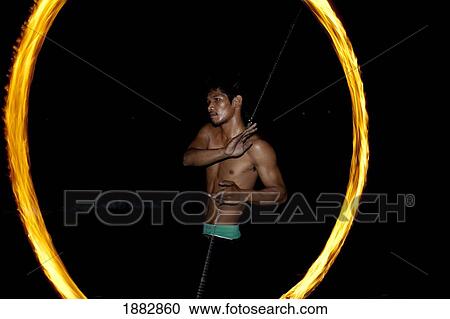 Stock Image - Man Dances With Fire; Samui Island, Koh Samui, Thailand. Fotosearch
