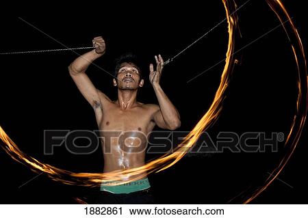 Stock Image - Man Dances With Fire; Samui Island, Koh Samui, Thailand. Fotosearch