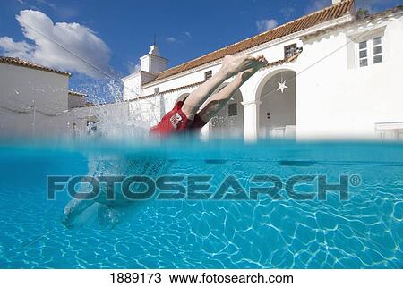 Man Diving Into Swimming Pool, Split Level View Large Photo Image Stock Image - Man Diving Into Swimming Pool, Split Level. Fotosearch