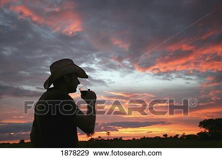 Man Enjoying A Drink At Sunset View Large Photo Image Stock Photo - Man Enjoying A Drink At Sunset. Fotosearch