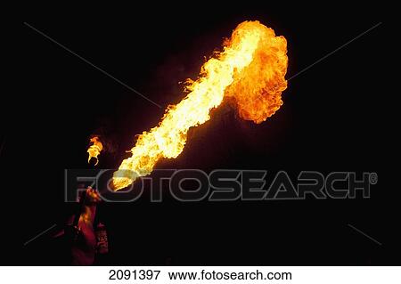 Stock Photo - Man Fire Breathing Large Fireball At Hastings Bonfire Night, East Sussex, Uk. Fotosearch