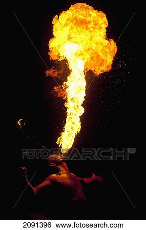 Stock Photograph - Man Fire Breathing Large Fireball At Hastings Bonfire Night, East Sussex, Uk. Fotosearch