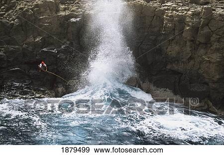 Stock Photo - Man Fishing At Coast. Fotosearch
