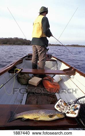 Man Fishing For Wild Brown Trout In A Row Boat View Large Photo Image Stock Image - Man Fishing For Wild Brown Trout In A Row Boat. Fotosearch