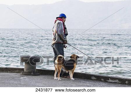 Stock Photo - Man fishing in Lake Toba, Samosir Island, Lake Toba, North Sumatra, Indonesia. Fotosearch