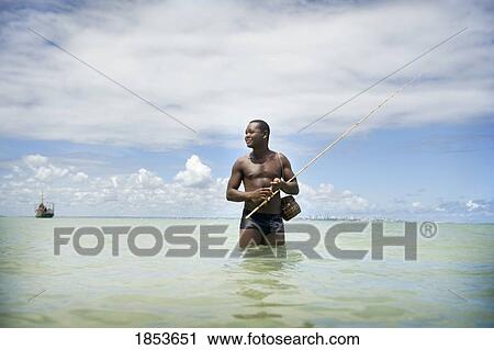 Stock Image - Man Fishing In Ocean, Brazil. Fotosearch