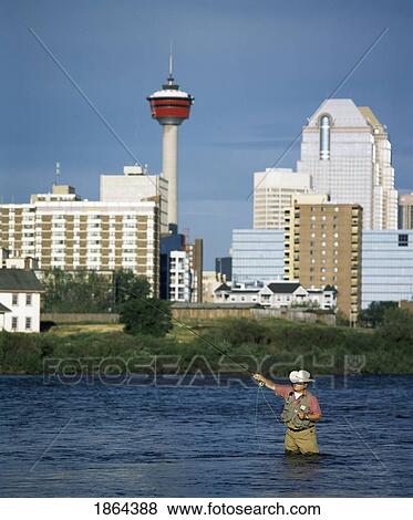 Man Fishing In The Bow River, Calgary, Alberta, Canada View Large Photo Image Stock Photo - Man Fishing In The Bow River, Calgary, Alberta, Canada. Fotosearch