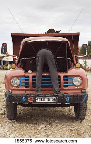 Stock Photography - Man Fixing An Old Truck, Essaouira, Morocco. Fotosearch