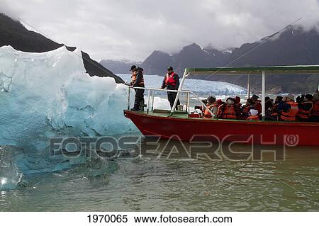 Man Getting Ice From An Iceberg In Laguna San Rafael, Laguna San Rafael National Park, Aysen Region, Chile View Large Photo Image Stock Photography - Man Getting Ice From An Iceberg In Laguna San Rafael, Laguna San Rafael National Park, Aysen Region, Chile. Fotosearch