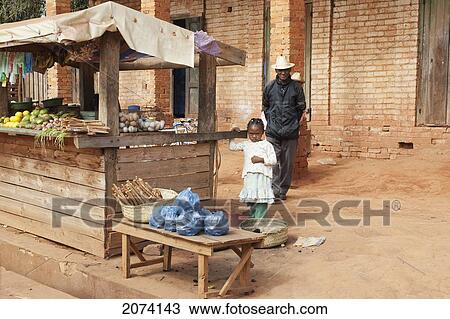 Man & Girl By A Food Stall In Ambalavao, Fianarantsoa Province, Madagascar View Large Photo Image Stock Image - Man & Girl By A Food Stall In Ambalavao, Fianarantsoa Province, Madagascar. Fotosearch