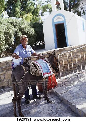 Stock Image - Man Going Up Steps With Donkey. Fotosearch