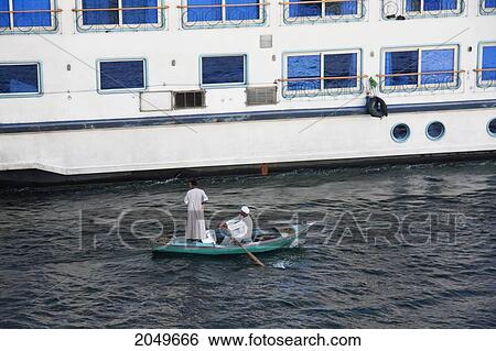 Stock Photograph - Man In A Boat In The Nile River Selling Textiles, Esna, Qina, Egypt. Fotosearch