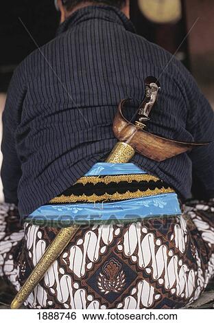 Stock Photograph - Man In A Ceremonial Costume With Sword In Sash. Fotosearch