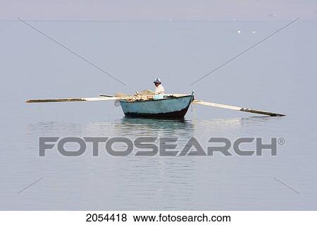 Man In A Fishing Boat On Lake Qarun, El Fayoum, Egypt View Large Photo Image Stock Photo - Man In A Fishing Boat On Lake Qarun, El Fayoum, Egypt. Fotosearch