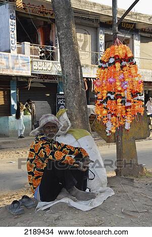Man In An Orange Lowered Shirt Sells Orange Plastic Puja Flowers, Karnataka, India View Large Photo Image Picture - Man In An Orange Lowered Shirt Sells Orange Plastic Puja Flowers, Karnataka, India. Fotosearch
