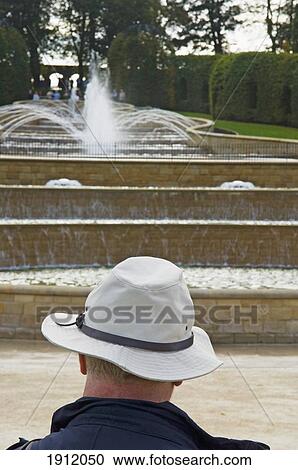 Stock Image - Man In Front Of Grand Cascade In Alnwick Garden, Alnwick, Northumberland, England, Uk. Fotosearch