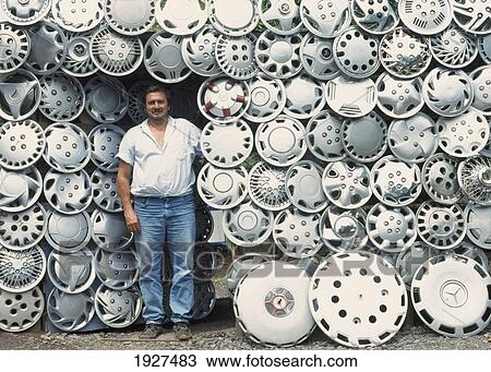 Man In Front Of Lots Of Hubcaps View Large Photo Image Stock Image - Man In Front Of Lots Of Hubcaps. Fotosearch