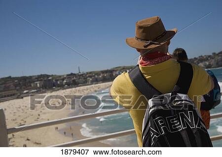 Stock Photo - Man In Hat Looking Out Over Bondi Beach. Fotosearch