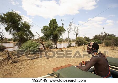 Stock Photo - Man In Jeep On Safari By River. Fotosearch