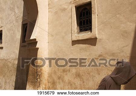 Stock Photo - Man In Jellabah Walking Through Medina. Fotosearch