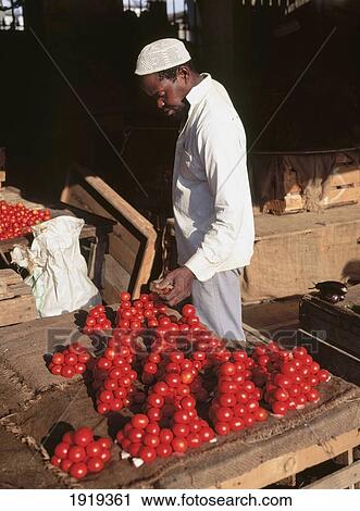 Stock Image - Man In Market With Tomatoes. Fotosearch