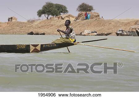 Man in pirogues (small boats) fishing in the Niger River between Mopti and Lake Debo, Mali View Large Photo Image Stock Photograph - Man in pirogues (small boats) fishing in the Niger River between Mopti and Lake Debo, Mali. Fotosearch
