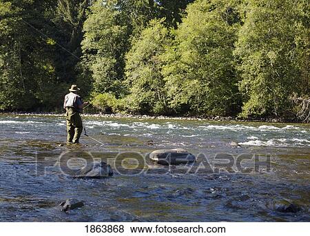 Stock Photo - Man In River, Elk Falls; British Columbia, Canada. Fotosearch