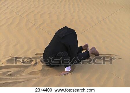 Man in smart suit with head buried in the sand; Dubai, United Arab Emirates View Large Photo Image Stock Image - Man in smart suit with head buried in the sand; Dubai, United Arab Emirates. Fotosearch