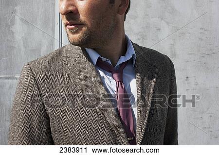 Stock Image - Man in suit jacket with pink tie; Langley, British Columbia, Canada. Fotosearch