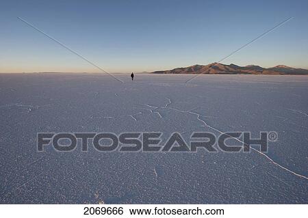 Man In The Salar De Uyuni, The World's Largest Salt Flat At Sunrise, Potosi Department, Bolivia View Large Photo Image Stock Photograph - Man In The Salar De Uyuni, The World's Largest Salt Flat At Sunrise, Potosi Department, Bolivia. Fotosearch