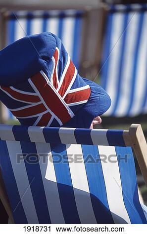 Stock Image - Man In Union Jack Hat In Sunchair. Fotosearch