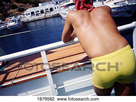 Stock Image - Man In Yellow Swim Trunks On A Ferry. Fotosearch