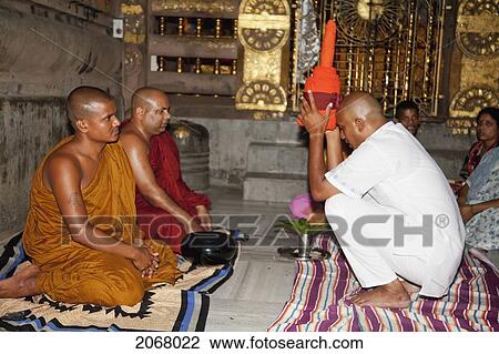 Stock Image - Man Is Vested As A New Monk, Mahabodi Temple, Bodhgaya, Bihar, India. Fotosearch