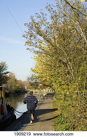 Stock Photo - Man Jogging Along Regents Canal, London, England, Uk. Fotosearch