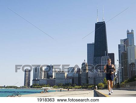 Man Jogging On Lakefront Path Along Oak Street Beach, Chicago, Illinois, Usa View Large Photo Image Stock Image - Man Jogging On Lakefront Path Along Oak Street Beach, Chicago, Illinois, Usa. Fotosearch