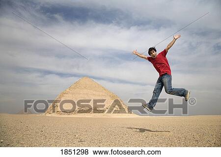 Man Jumping In Air With Pyramids In Background; Cairo, Egypt, Africa View Large Photo Image Stock Photo - Man Jumping In Air With Pyramids In Background; Cairo, Egypt, Africa. Fotosearch