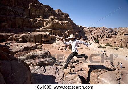 Man Jumping Near Monumental Nabataean Tombs View Large Photo Image Stock Photo - Man Jumping Near Monumental Nabataean Tombs. Fotosearch