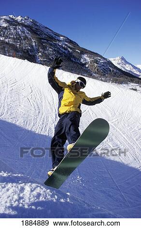 Man Jumping On Snowboard In The Alps View Large Photo Image Stock Photo - Man Jumping On Snowboard In The Alps. Fotosearch