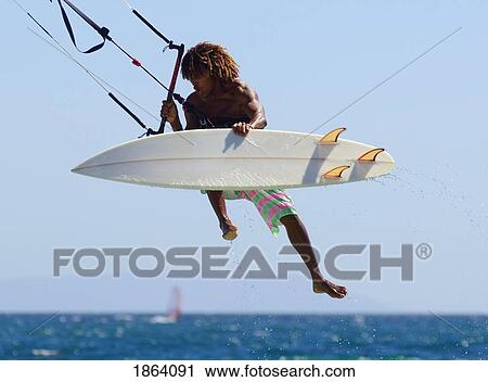 Stock Image - Man Kitesurfing. Fotosearch