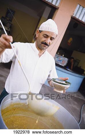 Man Ladeling Broth View Large Photo Image Stock Photo - Man Ladeling Broth. Fotosearch