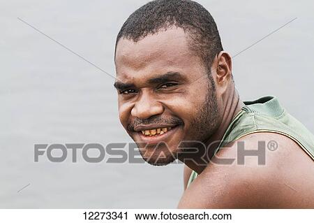 Stock Image - Man, Lake Sentani, Papua, Indonesia. Fotosearch