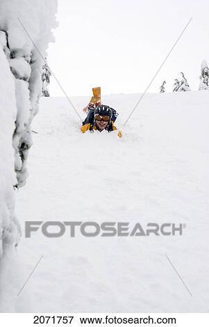 Stock Photo - Man Laughing In The Snow After Falling While Skiing, Lago Peak In The Cascade Mountains, Near The Coquihalla Highway, British Columbia. Fotosearch