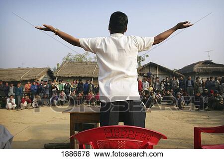 Stock Photo - Man Leading A Meeting In A Rural Village. Fotosearch
