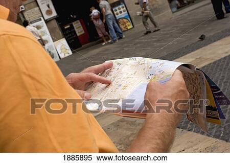 Stock Photography - Man Looking At A Street Map. Fotosearch