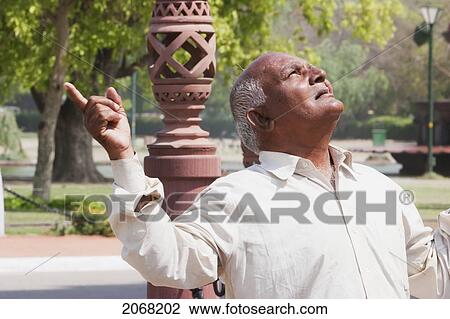 Stock Image - Man Looking At The India Gate, Delhi, Delhi, India. Fotosearch