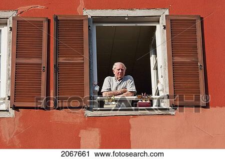Man Looking From A Window, Strasbourg, France View Large Photo Image Stock Image - Man Looking From A Window, Strasbourg, France. Fotosearch