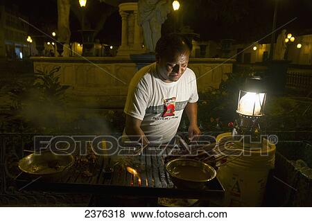 Man making anticuchos (meat skewers) at night, Trujillo, La Libertad, Peru View Large Photo Image Stock Photo - Man making anticuchos (meat skewers) at night, Trujillo, La Libertad, Peru. Fotosearch
