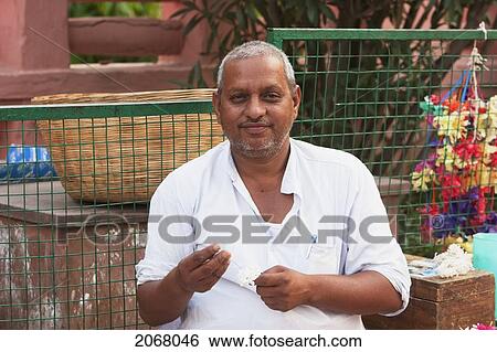 Man Making Flower Offerings For Sale Outside The Mahabodi Temple, Bodhgaya, Bihar, India View Large Photo Image Stock Photograph - Man Making Flower Offerings For Sale Outside The Mahabodi Temple, Bodhgaya, Bihar, India. Fotosearch