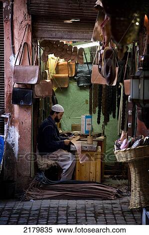 Stock Photography - Man making handbags from leather in the souk; Marrakesh, Morocco. Fotosearch